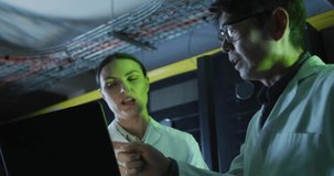 Two scientists standing in technical lab, tapping laptop screen and analyzing HUD data overlays. Researchers, collaboration, holographic, augmented, reality, interface, laboratory - Powered by Shutterstock - Get 15% off with code: PIKWIZARD15