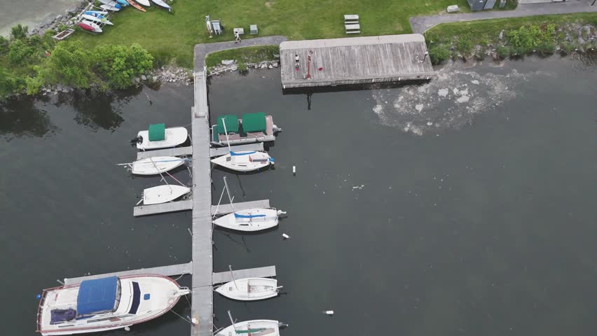 A small harbor along the shore of a lake where boats, jet boats, and other nautical vessels are docked and stored when not in use.