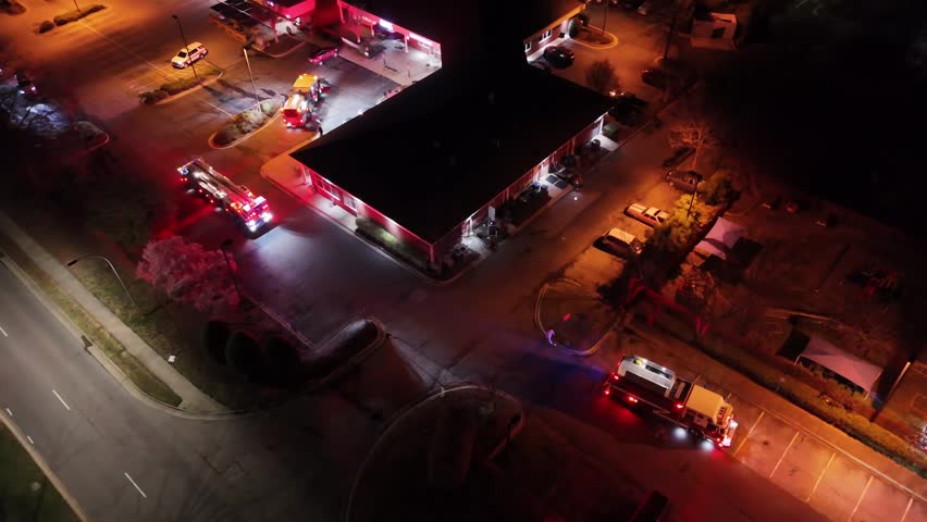 Aerial view of fire trucks responding to emergency call at night