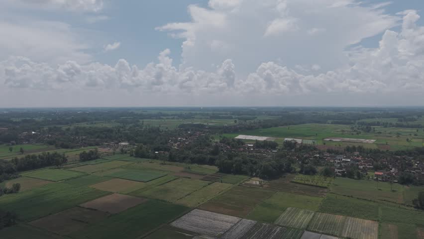 Green landscape with fields and cloudy sky
