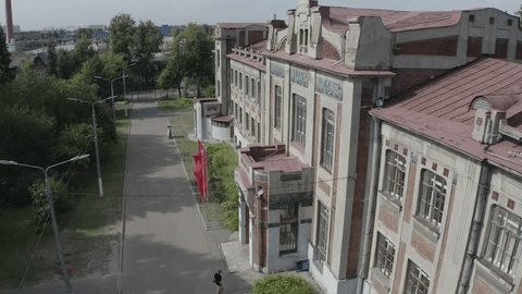 Drone Moving beside Historic Architecture Windows