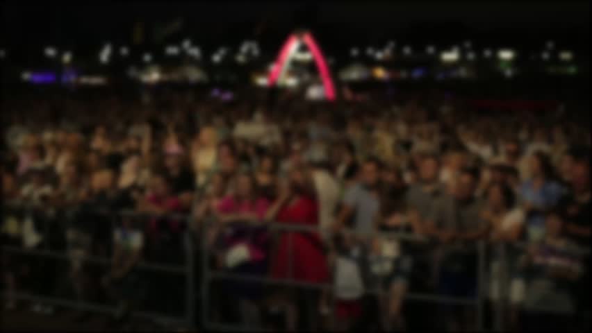People Watch Outdoor Concert With Glowing Lights.