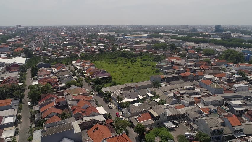 High-angle aerial drone view showcasing the dense urban sprawl and residential neighborhood of Rungkut in Surabaya, East Java, Indonesia