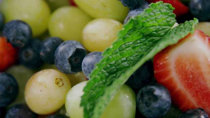 On load berry cluster staying while HUD overlaying wireframe boxes and round counter for food tech. Macro, fruit, grapes, blueberries, strawberry, mint, closeup
