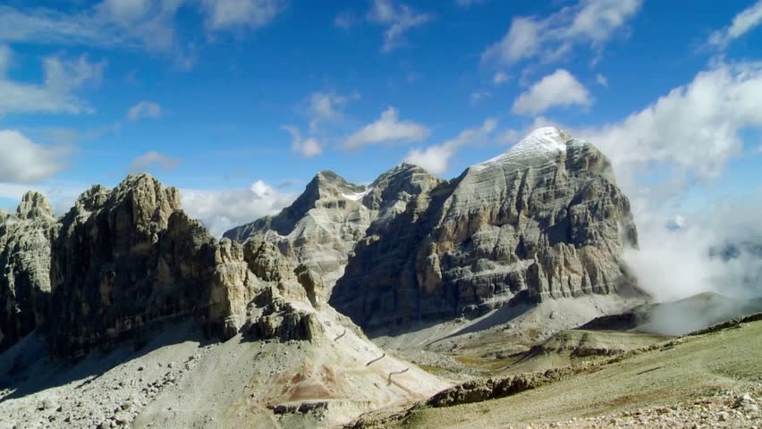 Dr.amatic view of the Tofane Mountains in the Dolomites, Belluno, showcasing extreme rugged terrain, sharp limestone peaks, deep shadows, alpine atmosphere, natural light, high detail, expansive landscape, clear sky, cinematic composition