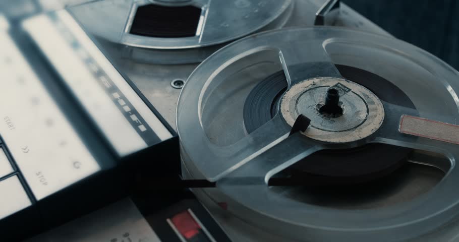 Close-up of a noir vintage tape recorder playing an old tape