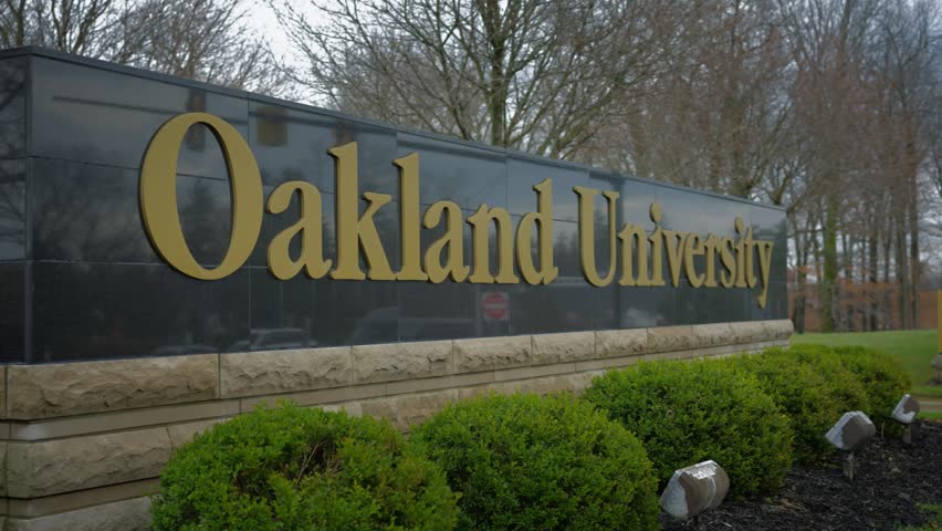 Dolly shot along a campus sign at Oakland University in Auburn Hills Michigan in daylight with smooth cinematic motion