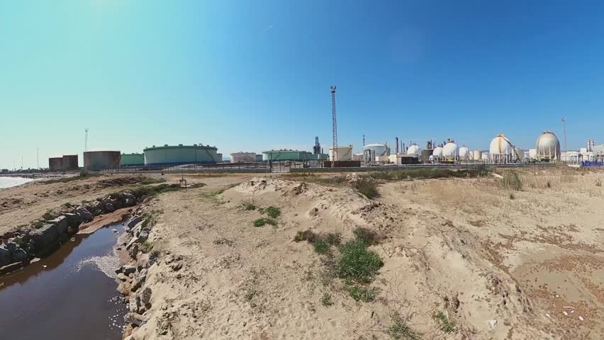 Panoramic view of the Oil Storage, Refining Plant on the Mediterranean coast. Environmental pollution, CO2 emissions, ecological disaster, toxic runoff. Iran War. Kuwait, Hormuz, and Kharg