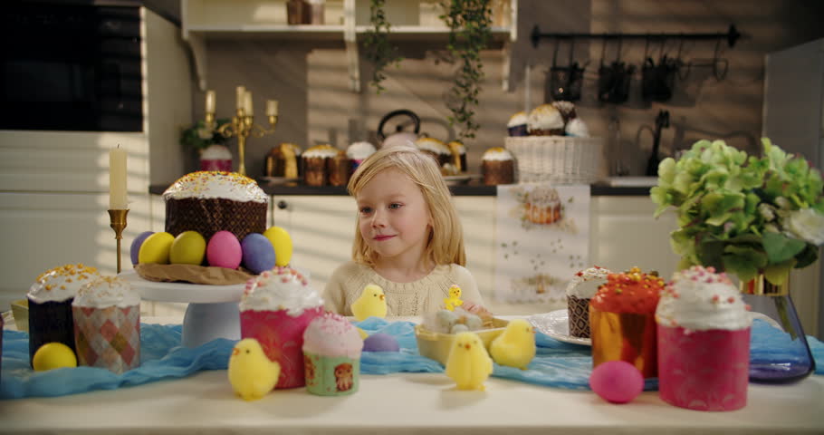 Little boy examining yellow chick at Easter table