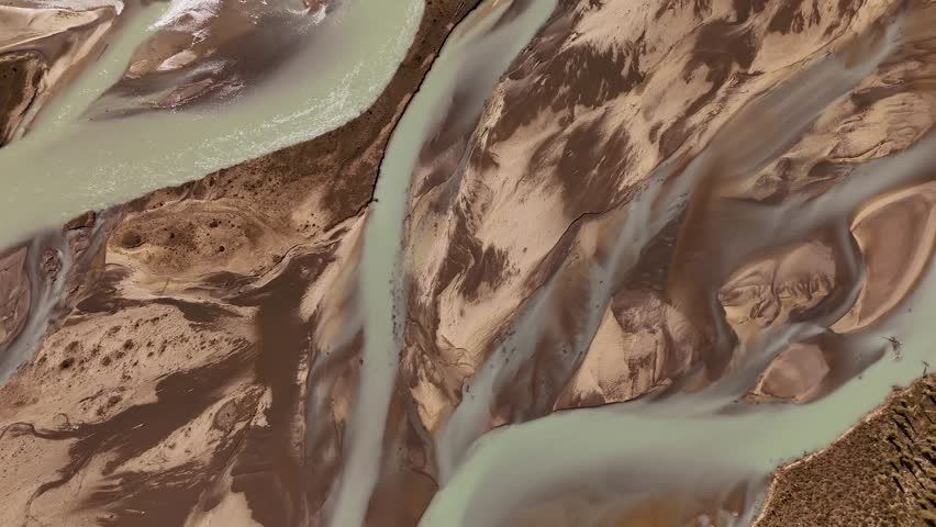 Aerial view of braided riverbeds and brown scree slopes along the Icefields Parkway, showing low water levels between Banff and Jasper National Parks, Alberta. Road trip in Canada. Rocky mountains.