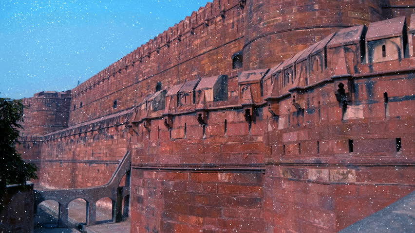 Red Fort of Agra built from red sandstone with white marble features, which served as the main residence of the emperors of the Mughal Dynasty built primarily by the Mughal Emperor Akbar in the Middle Ages in Agra, Uttar Pradesh, India. Other name is lal Kila. View through sparkling particles. Shot in motion