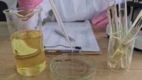 Scientist conducts experiment with liquids and glass tools in laboratory setting - Powered by Shutterstock - Get 15% off with code: PIKWIZARD15