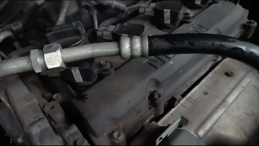 Car engine parts and tubes visible