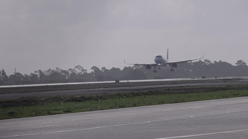 Small airplane landing in Porto airport in slow motion.