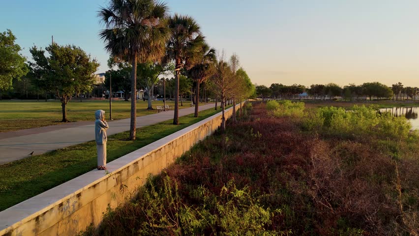 Watching Sunrise At Kissimmee Lakefront Park On Lake Toho, Florida. Peaceful Travel Scene With Waterfront Path And Morning Light
