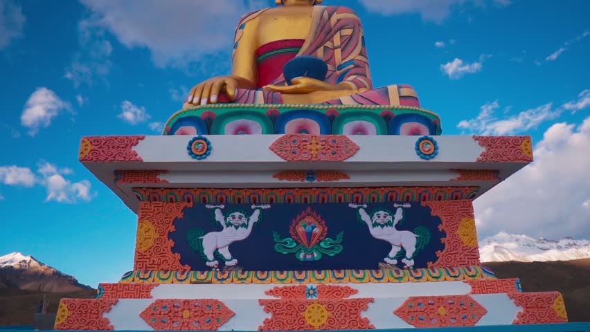 Langza Buddha statue in the village of Langza in the Spiti Valley, Himachal Pradesh, India. Giant Buddha statue and clouds in sky. Travel and summer holidays concept.