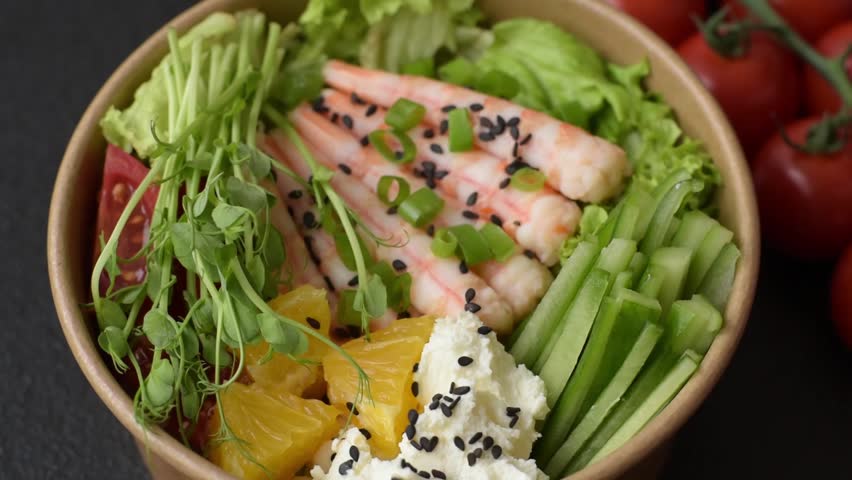 A prawn or shrimp bowl with rice, tomatoes, sauce, and vegetables, Asian food. Prawn or shrimp as a food background for your design