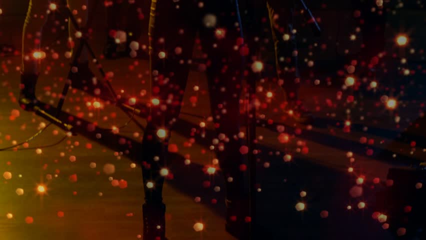 Camera opening singer moving to mic and singing to perform live, particle overlay pulsing over band. Vocalist, ensemble, stage, silhouette, bokeh, amber, rimlight