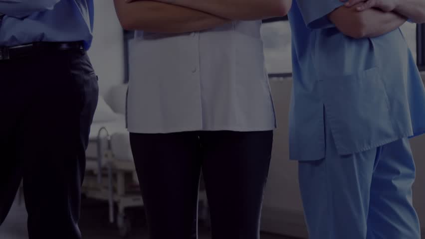 Medical team standing with stethoscopes, camera pulling back, globe centering, showing global care. Healthcare, clinicians, unity, holographic, overlay, futuristic, clinical