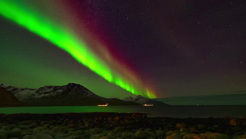 Stunning Aurora Borealis Time Lapse Over Snowy Mountains and Arctic Ocean with Vibrant Green and Red Northern Lights