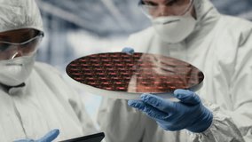 Innovating components, silicon wafers and team of technicians in production facility discussing. Collaborating, semiconductor substrates and teamworking engineers increasing quality, camera B - Powered by Shutterstock - Get 15% off with code: PIKWIZARD15