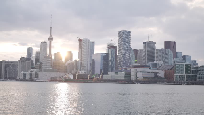 Toronto skyline with CN Tower at sunset over Lake Ontario, Canada.