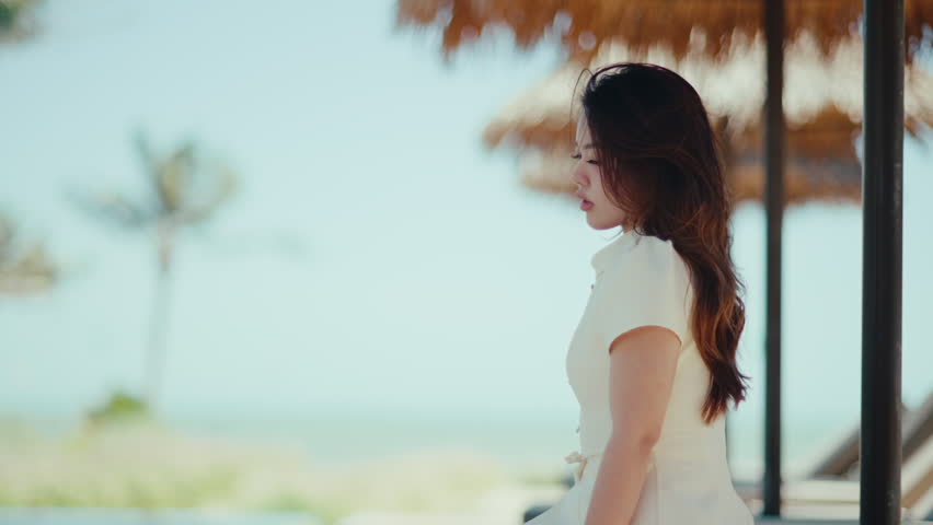 Woman relaxing by the beach, feeling serene and enjoying tropical summer vacation