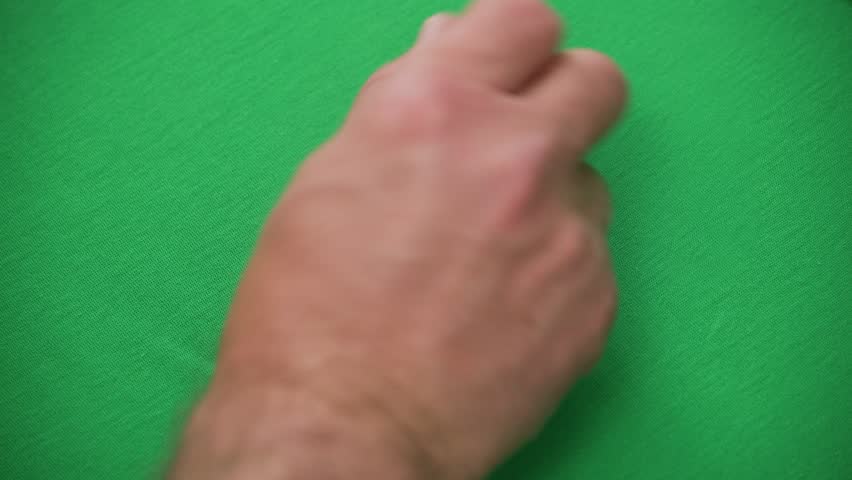 Hand holding multiple white dice over green felt symbolizing luck chance and gaming activity