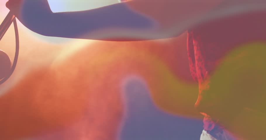 Vertical video: Woman singer tuning mic leaning singing performing music as flares revealing shadow. Stage, rehearsal, performance, microphone, backlight, lensflare, bokeh