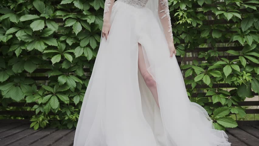 A beautiful young bride shows off her wedding dress