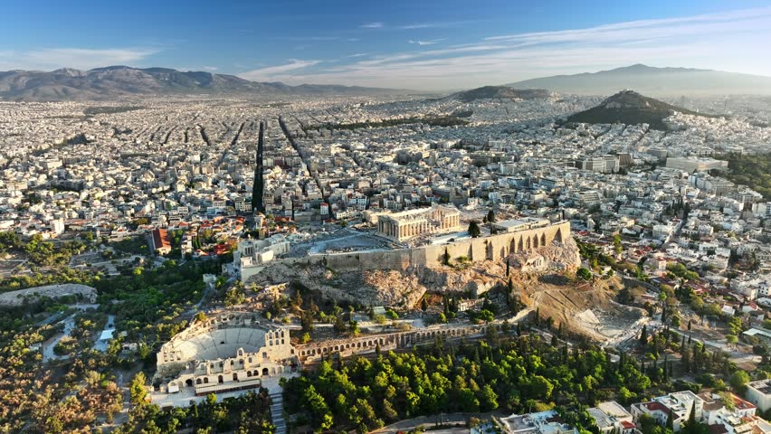 The Acropolis and Parthenon stand above the city of Athens, Greece. Drone aerial view shows the historic Acropolis ruins in Athens, Greece