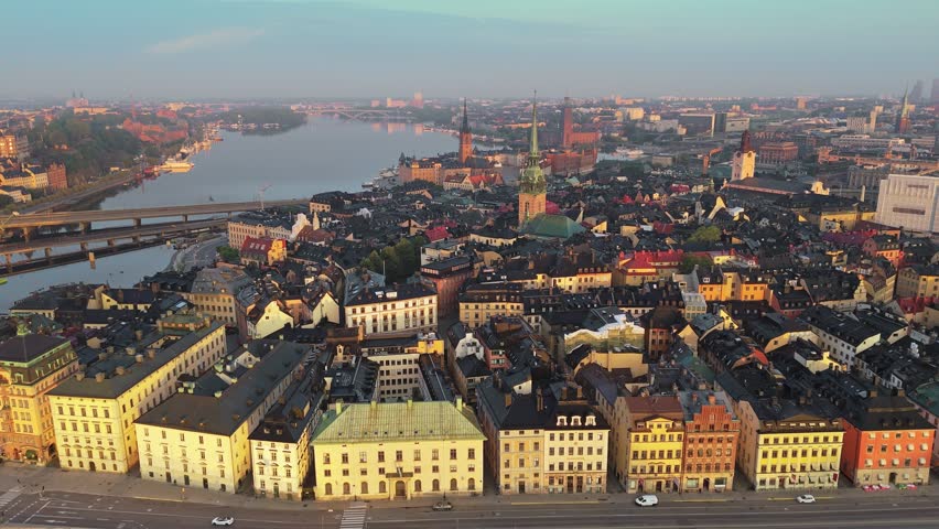 Colorful historic buildings fill Gamla Stan in Stockholm, Sweden. Evening light hits the old town district of Stockholm, Sweden. Panoramic city aerial, 4K UHD