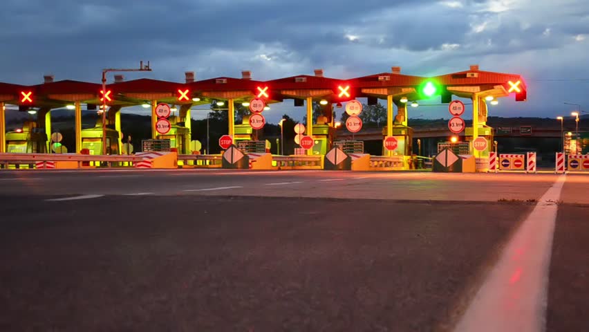 Highway Car Pay toll at sunrise, Night lights and Autos passing through toll