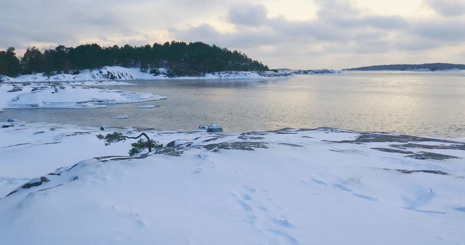 Winter scene of snow-covered rocky shores in cloudy weather, Porkkalanniemi, Kirkkonummi, Finland, Europe, 