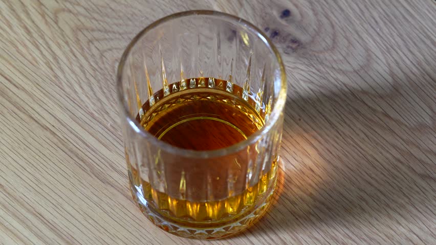 Ice Cubes Dropping into Crystal Glass Full of Whiskey Close Up 4K – Splash Luxury Drink