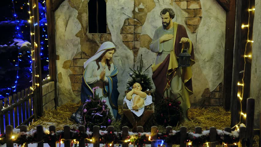 Nativity scene figures of Baby Jesus, Virgin Mary, and Joseph in Christmas stable display