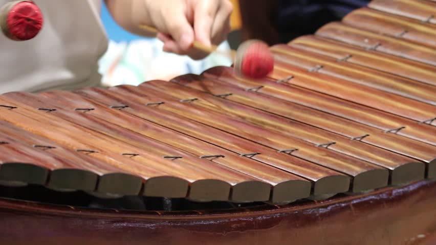 Musician Playing a Traditional Thai Ranat Ek Wooden Xylophone with Mallets