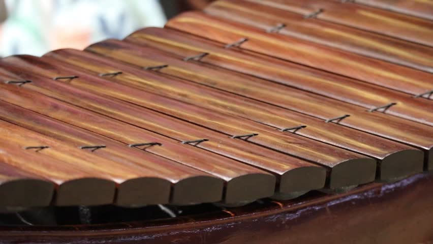 Close Up of Musician's Hands Playing a Traditional Thai Ranat Ek Wooden Xylophone with Mallets.