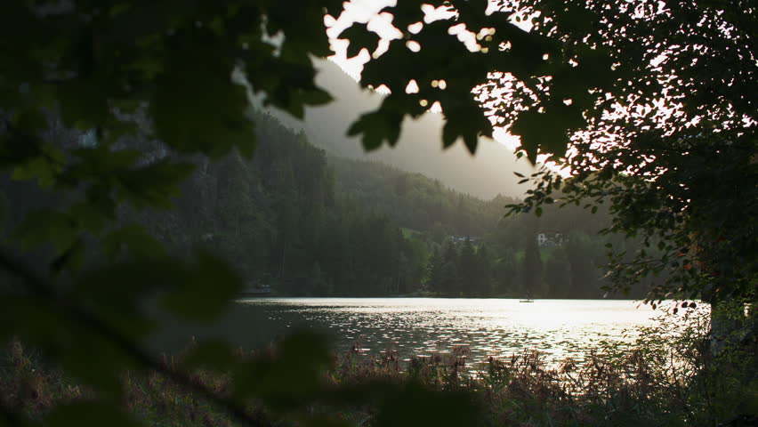 Scenic landscape of Piburger See lake in Austrian Alps surrounded by forested mountains with peaceful nature and European travel destination