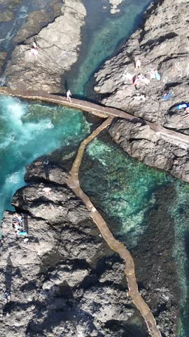 Aerial view of Garachico natural pools with people Tenerife