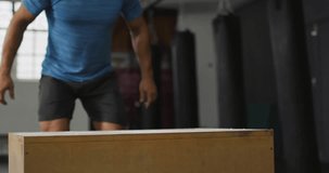 Fit man crouching, driving, doing box jumps for fitness while blue charts overlay footwork. Plyometric, platform, gym, athlete, explosive, balance, chalk - Powered by Shutterstock - Get 15% off with code: PIKWIZARD15
