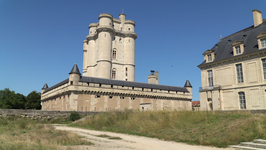 The majestic medieval Donjon tower of Vincennes Castle in Paris, France. Sunny day, clear blue sky.