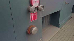 Closeup of fire fitting on building wall. Urban infrastructure with safety signage and textured metal fittings - Powered by Shutterstock - Get 15% off with code: PIKWIZARD15