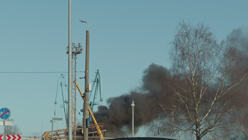 Huge dark smoke emerging far away
