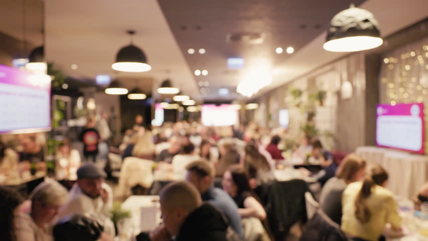 Evening dining at lively cafe. Vivid scene of city cafe at night. Vibrant evening environment within bustling city refreshment spot. An energetic and warm ambiance inside busy coffee shop at night