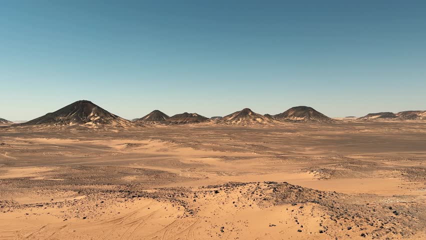Cinematic landscape of black rocky hills in Sahara desert