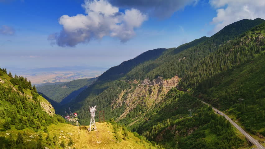Flying over the mountain tops covered with pine tree woods. Jaw-dropping scenery of wild nature of Romania.