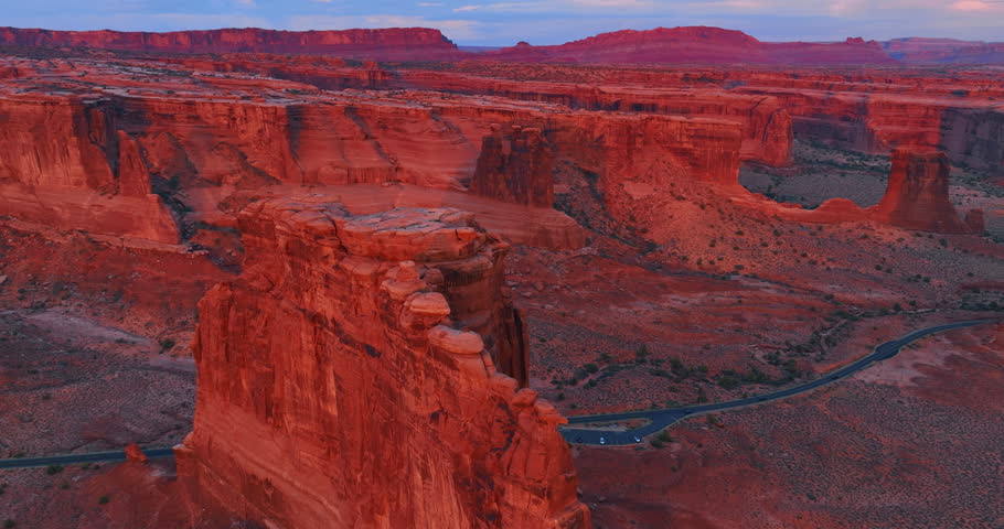 Red canyons with flat tops in the light of sunset. Aerial perspective on the Arches National Park, Utah, USA.
