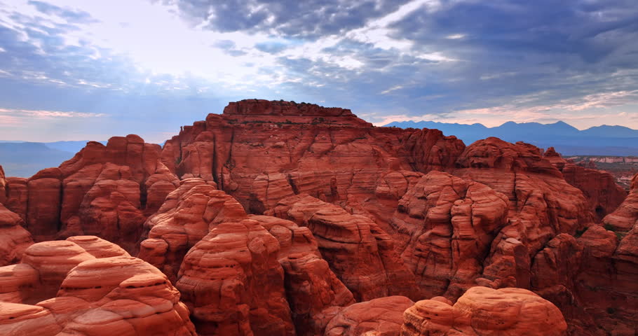 Approaching the top of the red canyon rounded by the power of wind. Drone footage above the Arches National Park, Utah, USA.