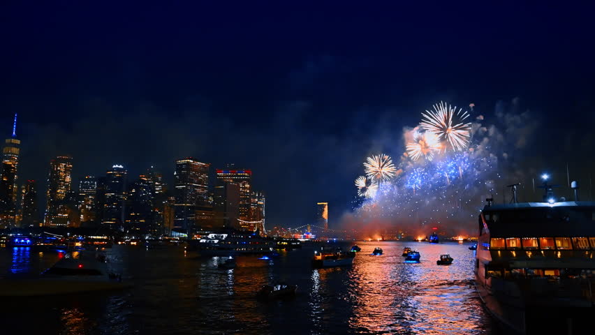 Firework celebration in New York, USA. 4th July festival over the East River. Numerous boats watch the show.